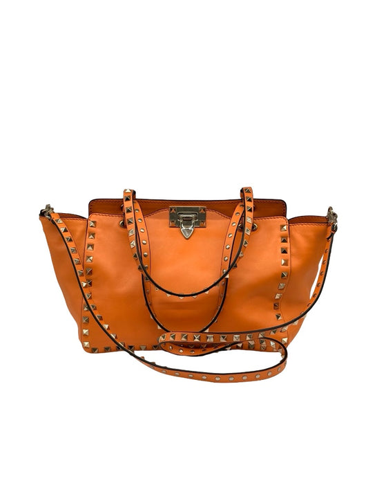 Valentino Garavani Orange Rockstud Trapeze Handbag.