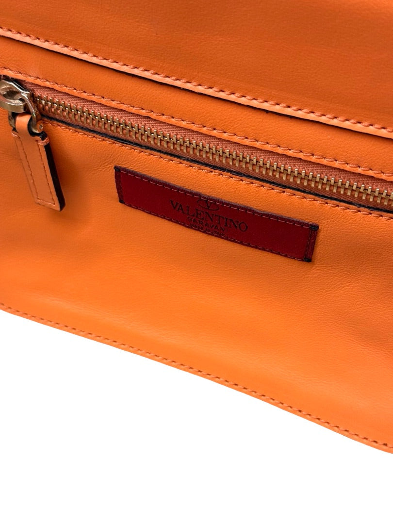 Valentino Garavani Orange Rockstud Trapeze Handbag.