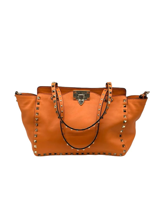 Valentino Garavani Orange Rockstud Trapeze Handbag.