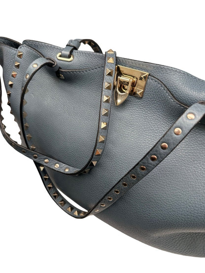Valentino Garavani Blue Large Studded Rockstud Leather 'Trapeze' Crossbody Bag.