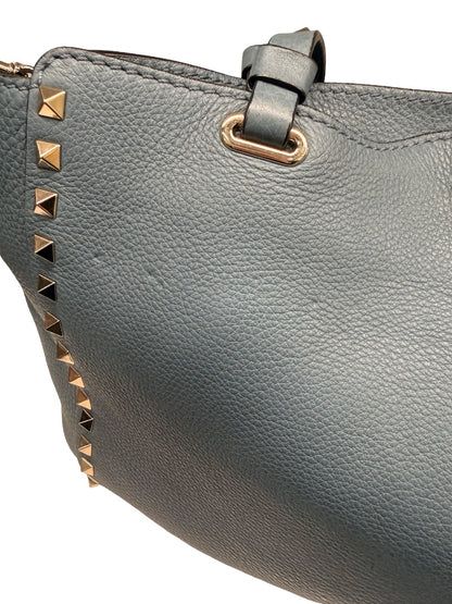 Valentino Garavani Blue Large Studded Rockstud Leather 'Trapeze' Crossbody Bag.