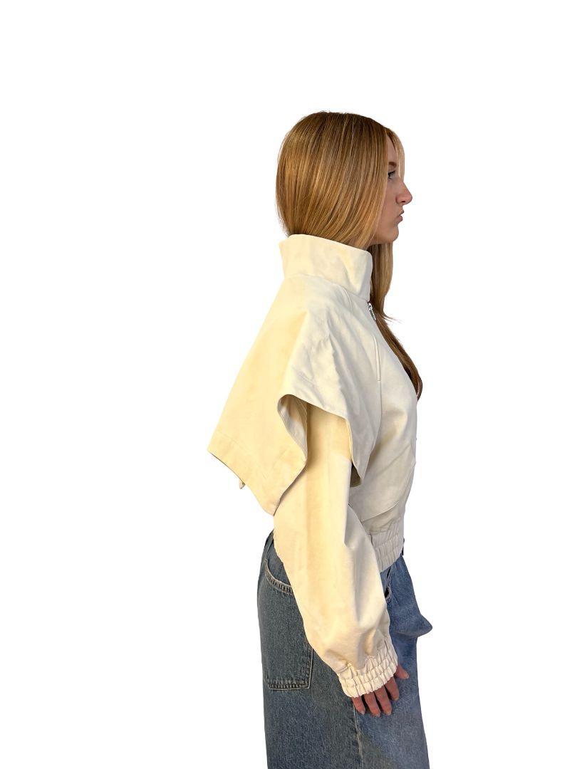 AKNVAS Cream Fake Leather Jacket w/ Cape Sleeve Overlay. Size: XS