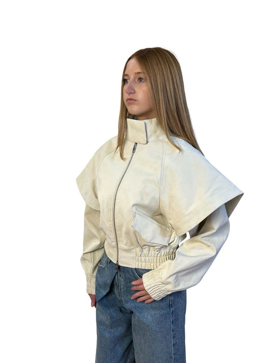AKNVAS Cream Fake Leather Jacket w/ Cape Sleeve Overlay. Size: XS